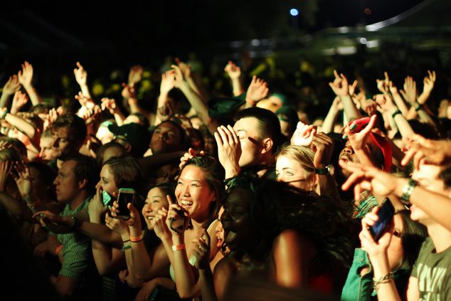 Students crowd near the front of the stage at Spring Concert