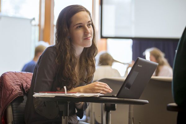 A student listening to another student in a group discussion
