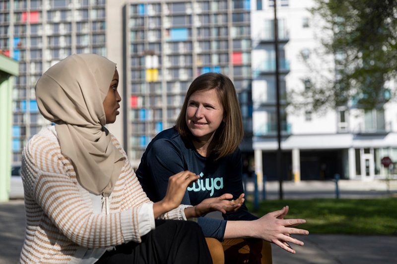 Jamie Glover ’06 and Fatimah Hussein discuss a point in a city park