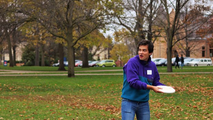 student preparing to throw a frisbee on the bald spot
