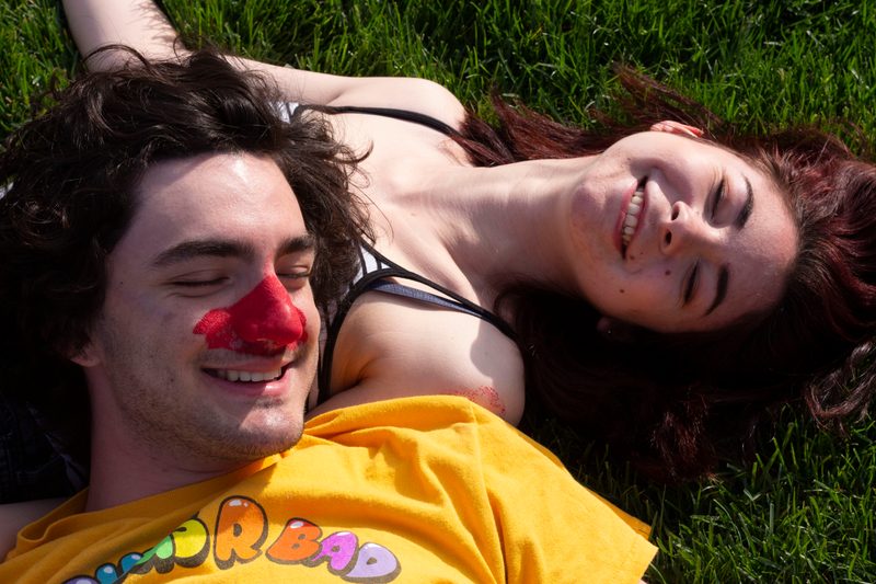 Lucas and Caroline smiling in the grass