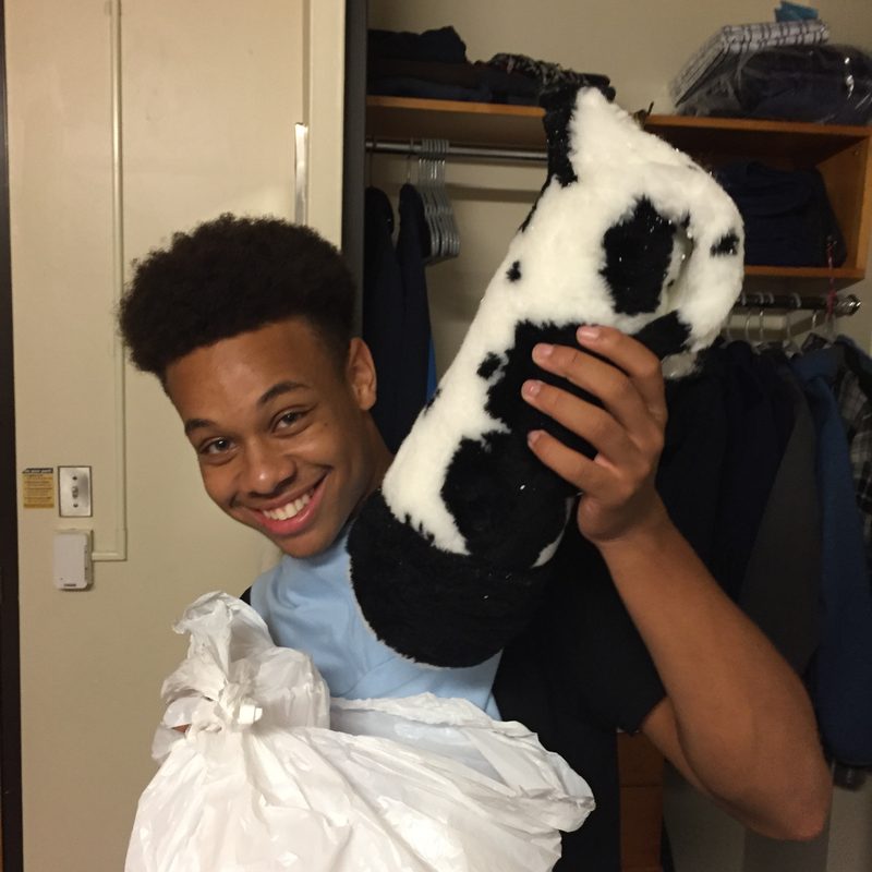 Indoor, happy young adult holding a stuffed cow leg