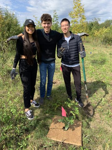 Friends celebrate planting trees in the arboretum. 