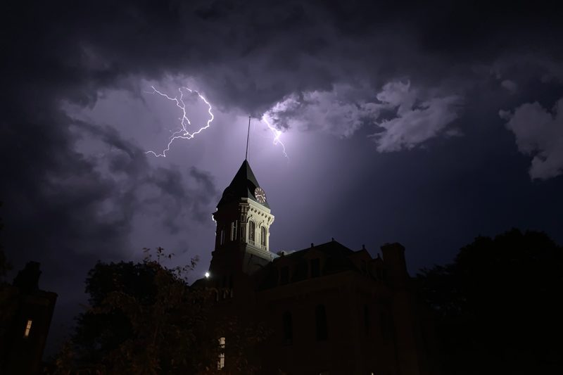 Bolts of lightning strike behind and above Willis Hall's clocktower
