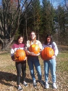 girls and carved pumpkins