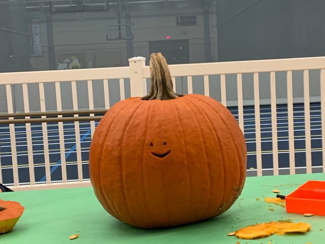 Pumpkin with small carved smiley face