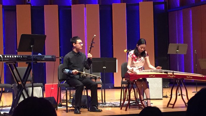Two students performing erhu and guzheng on stage