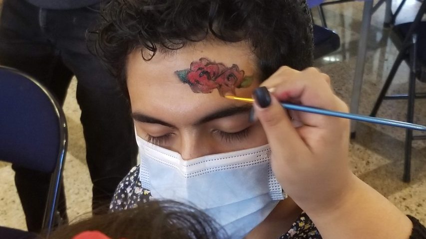 Red Roses Being Painted on a Forehead