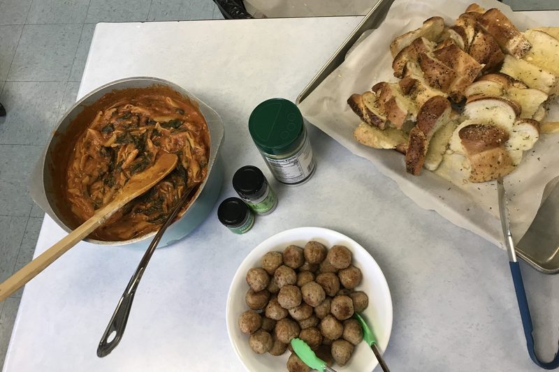 Pasta, garlic bread, and meatballs.
