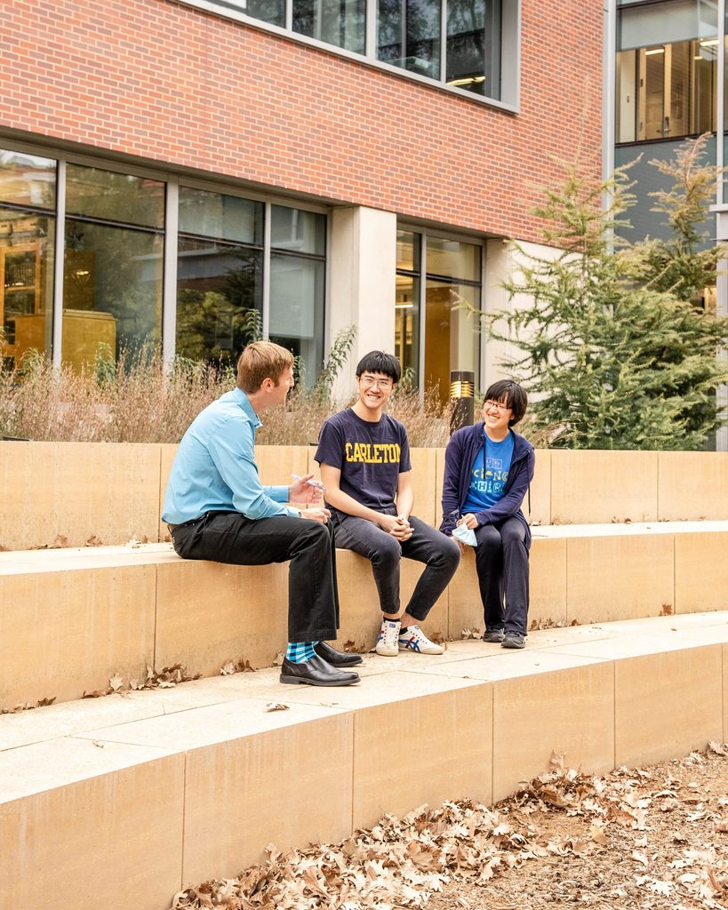 Two students with a professor