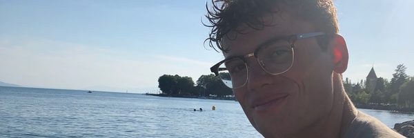 Harrison sitting by a lake