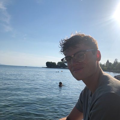 Harrison sitting by a lake