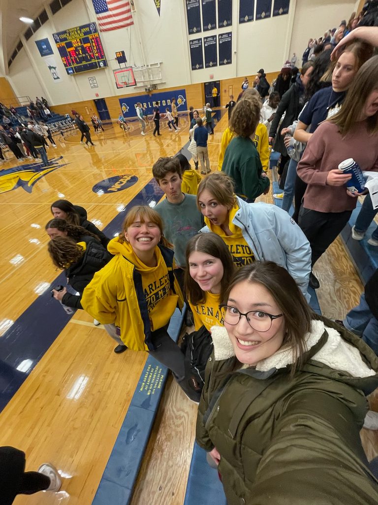 Five students taking a selfie on the basketball court