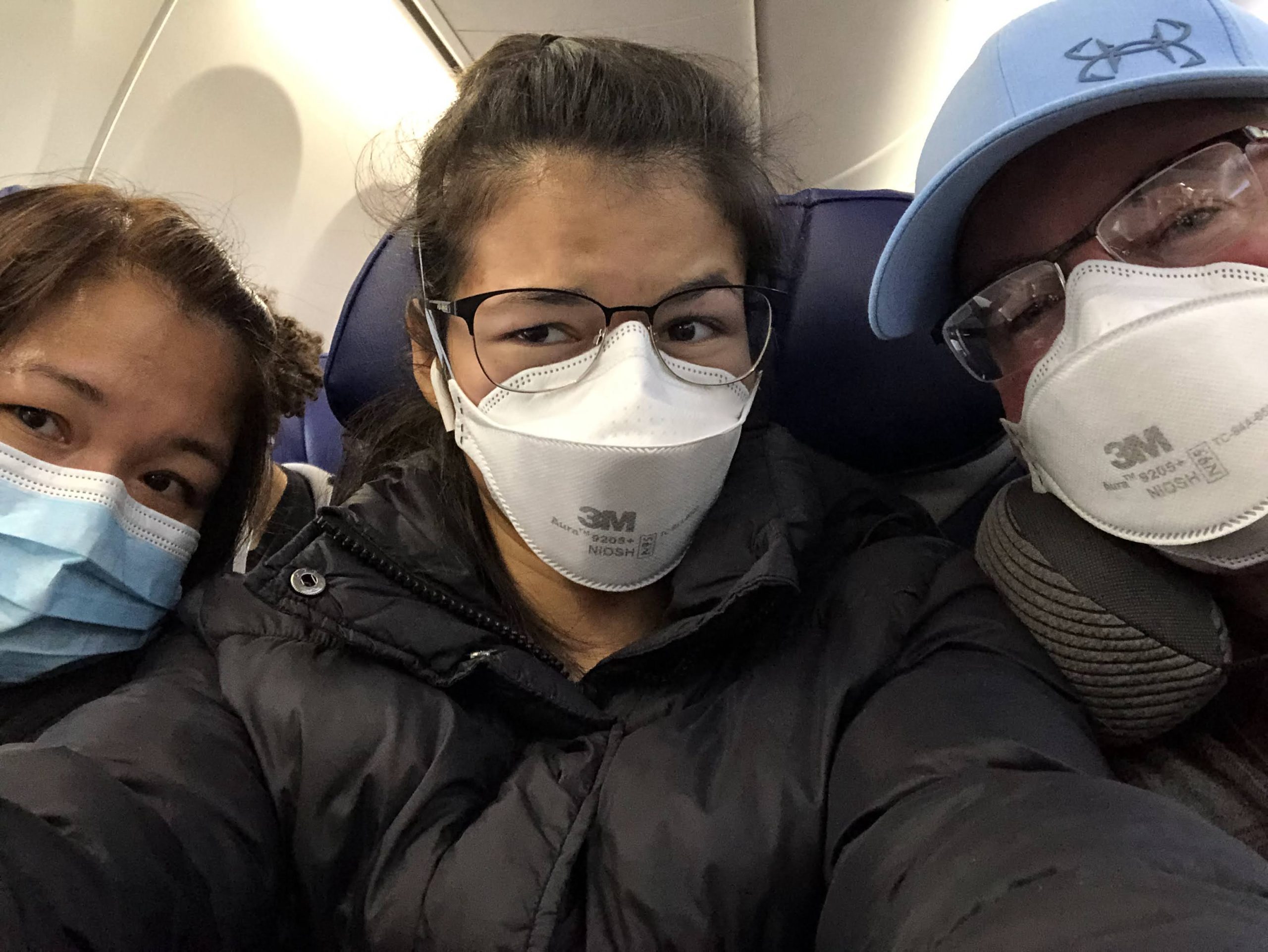 Lexi and her parents on the plane