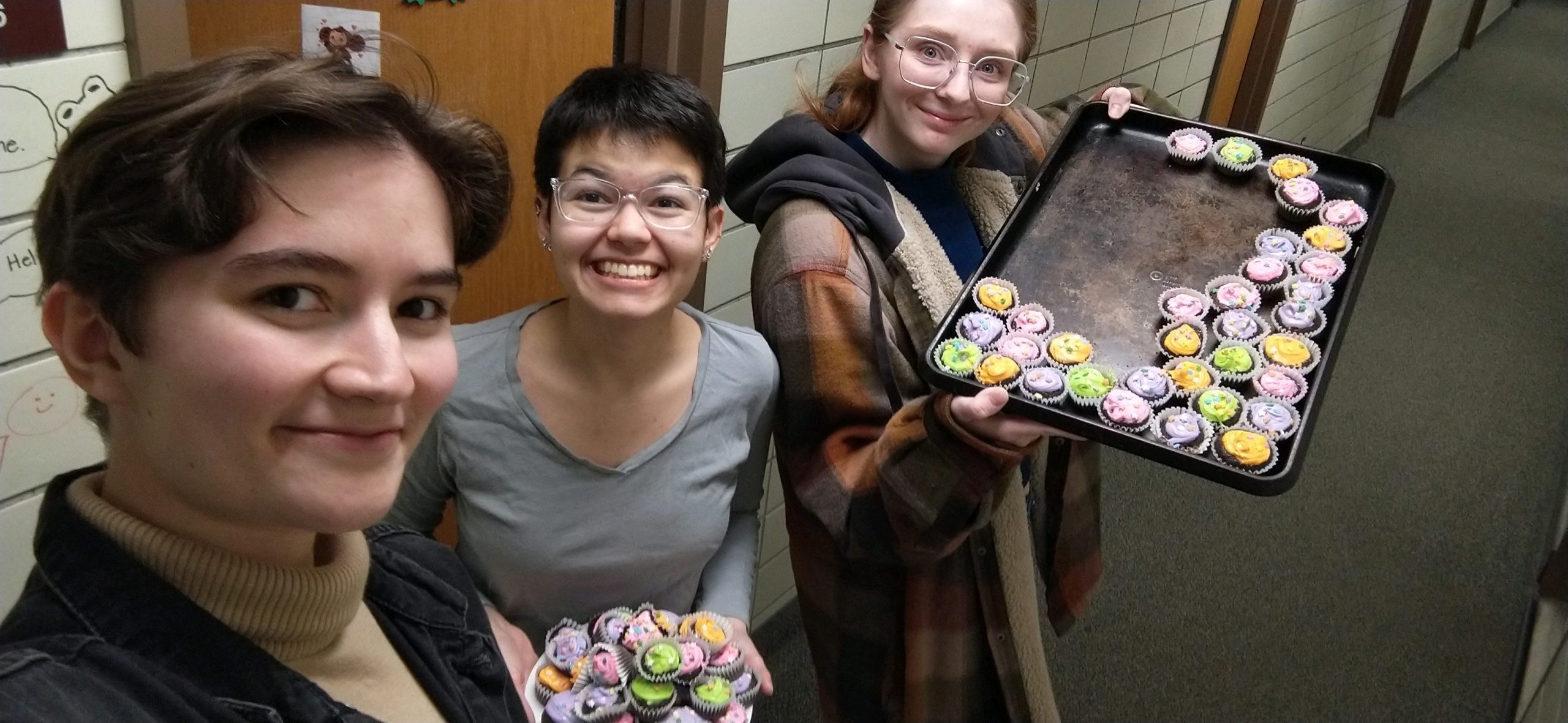 3 students with cupcakes