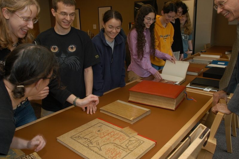 Students look at printmaking books from the Library's special collections.