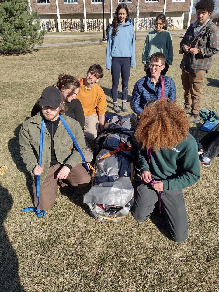 people preparing to carry a patient out