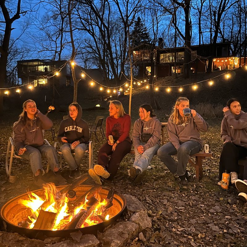 people sitting around a bonfire