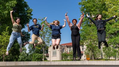 5 people jump on the Carleton College sign