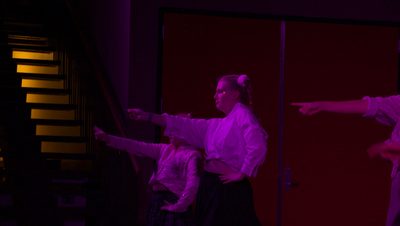 a girl in white dances