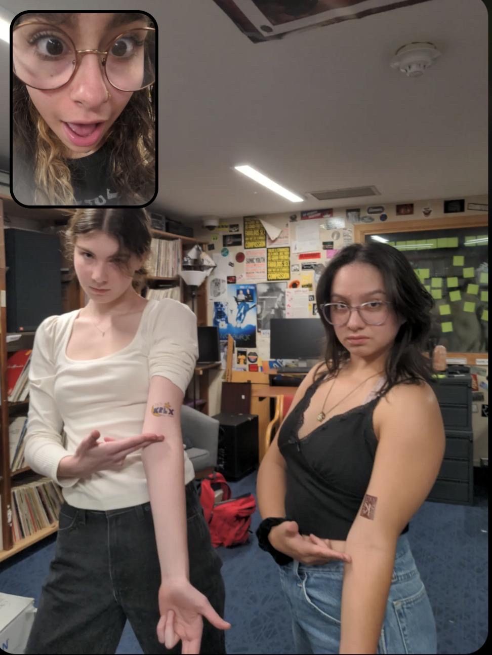 Two girls showing off their fake arm tattoos