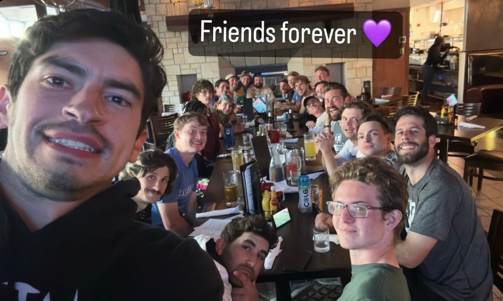 team poses for the camera at dinner