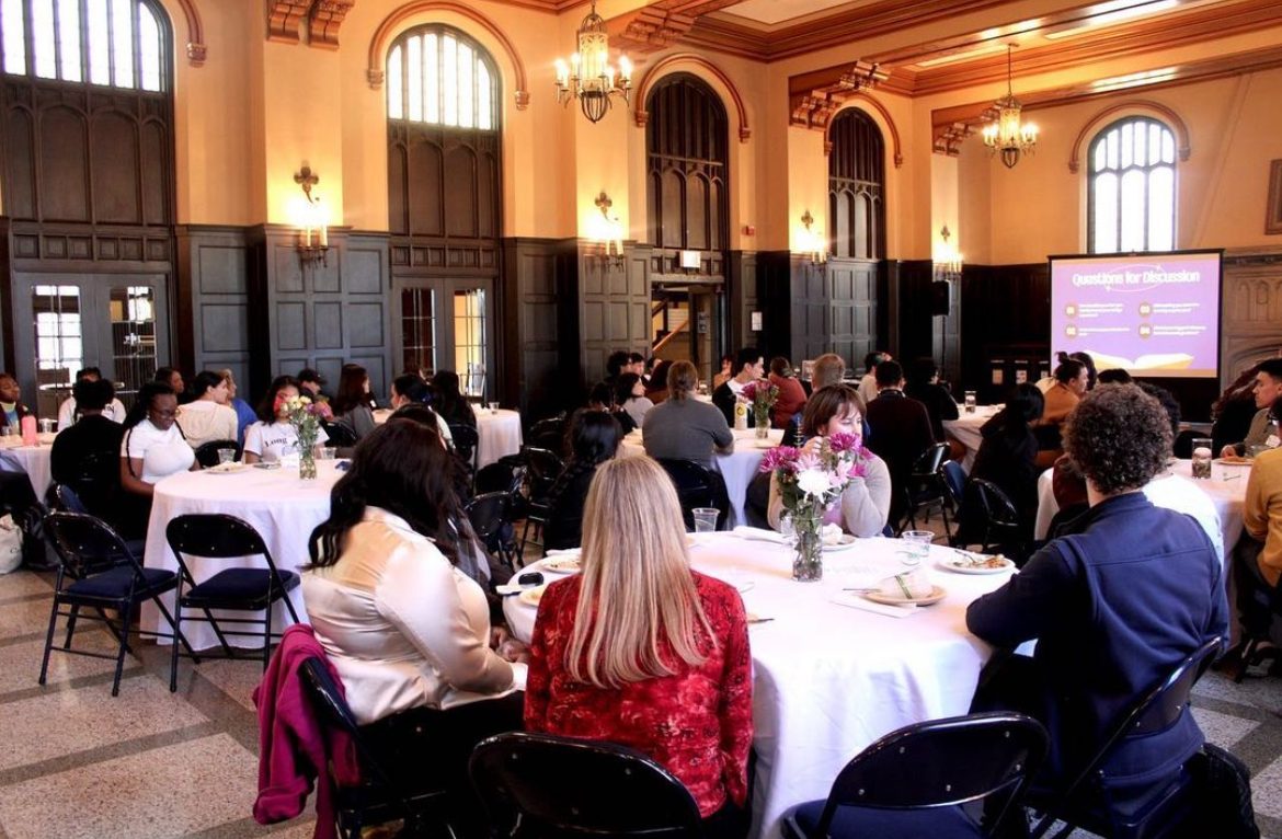 Large room of people eating dinner.