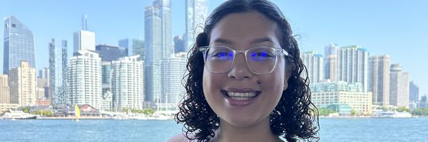 Diana smiling in front of a city skyline