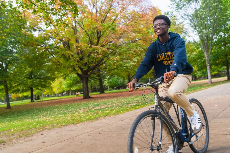 Student biking across campus