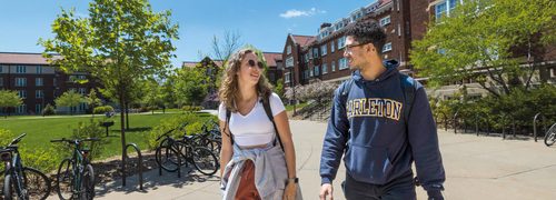 Two students walking across campus