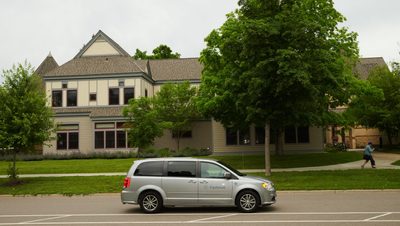 Car driving down campus road