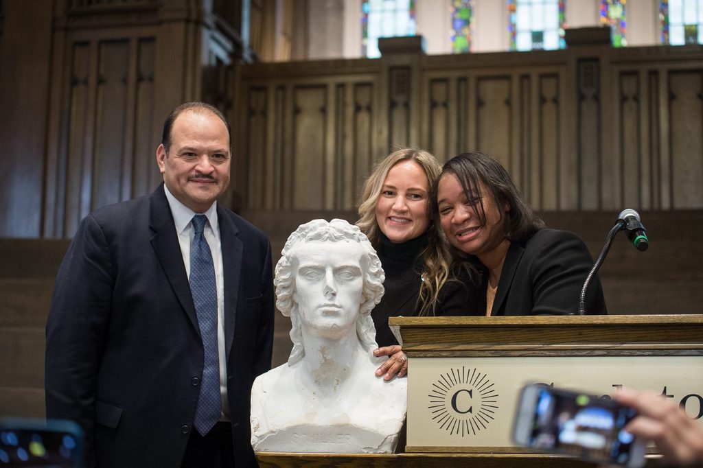 staff members pose with schiller inside the chapel