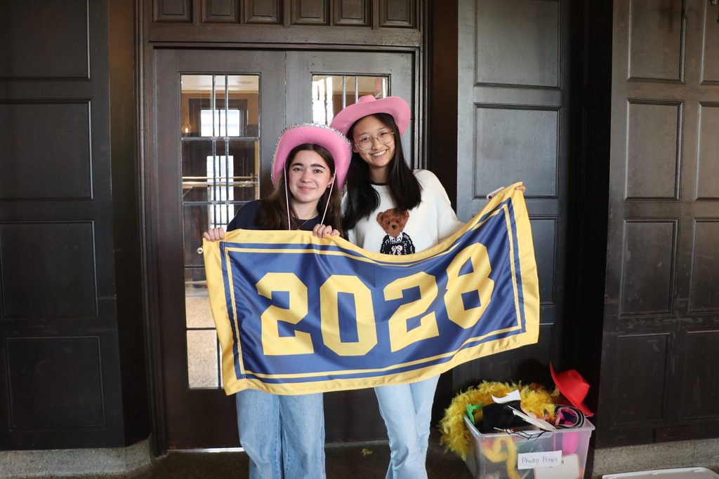 Two students holding a class of 2028 banner