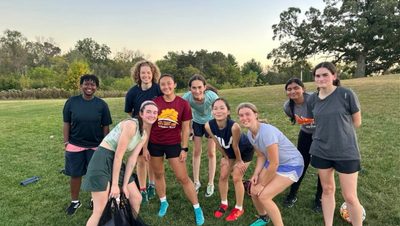 People from the Womxn's club soccer team at practice standing by the hill of three oaks.