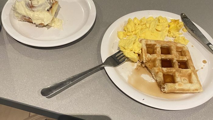 A cinnamon roll and waffles