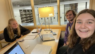 3 people in study room in library
