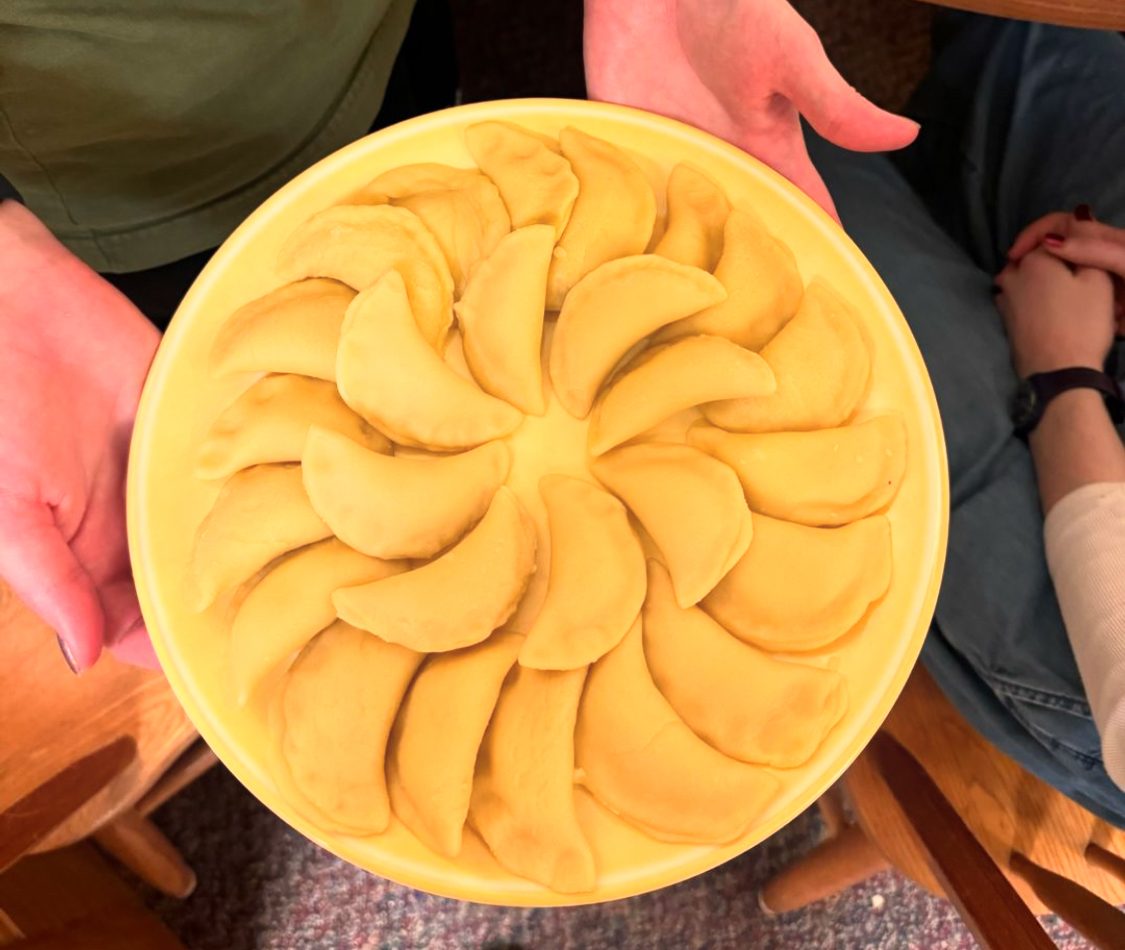 Hands holding vereniki plate