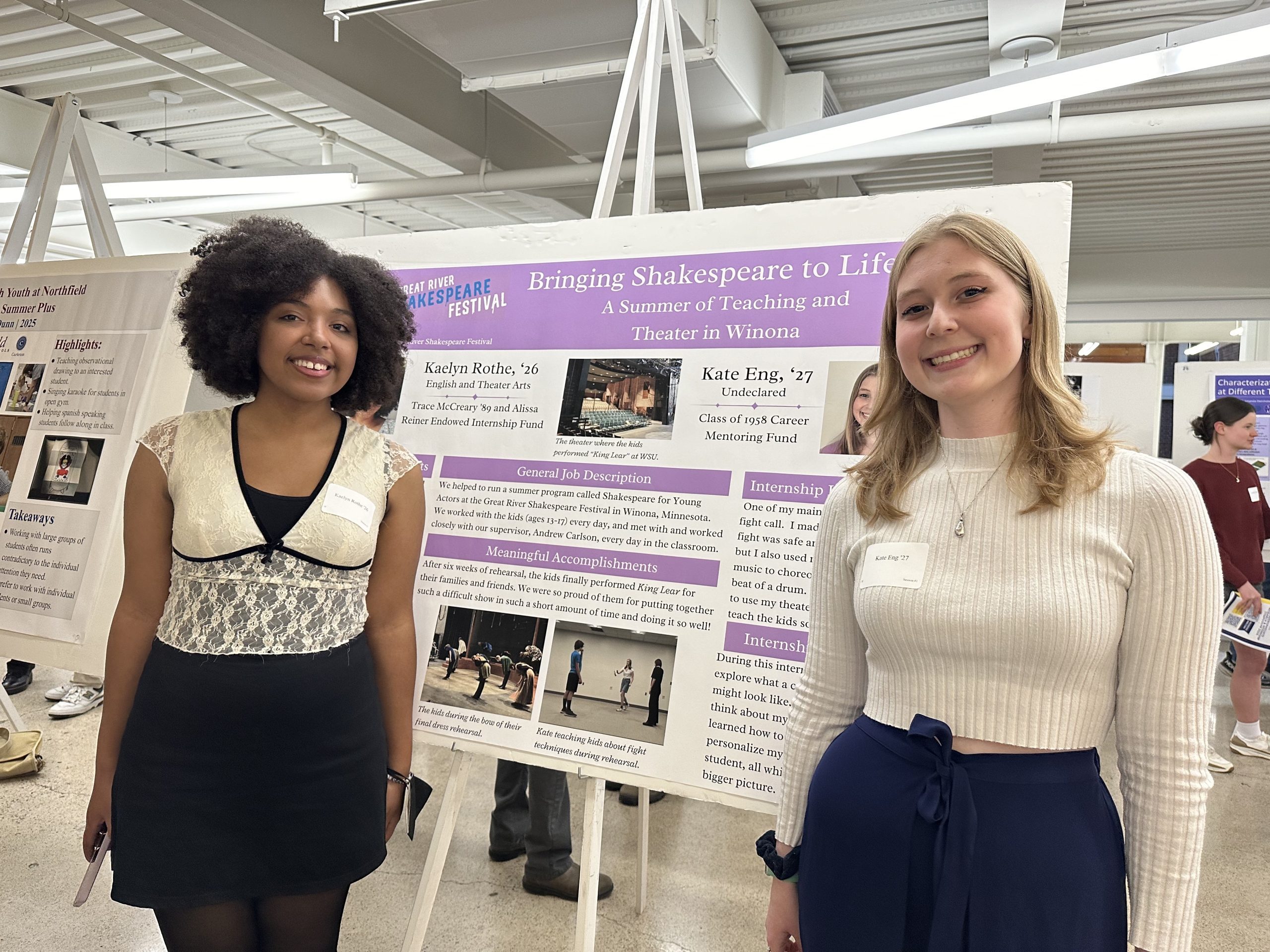 Two girls in front of their poster presentation