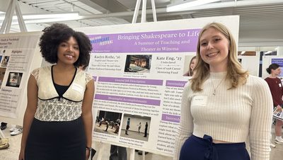 Two girls in front of their poster presentation