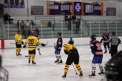 Carleton men's ice hockey players lining up for a faceoff