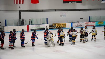 Macalester and Carleton women's ice hockey handshake line on the ice