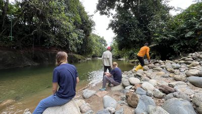 People on the banks of a swimming hole