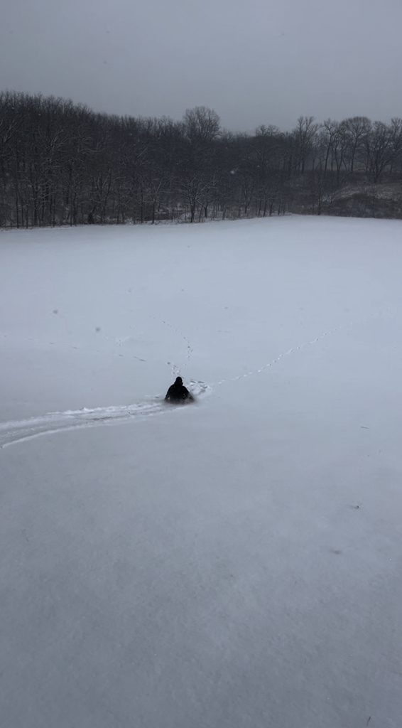 person sledding down a hill