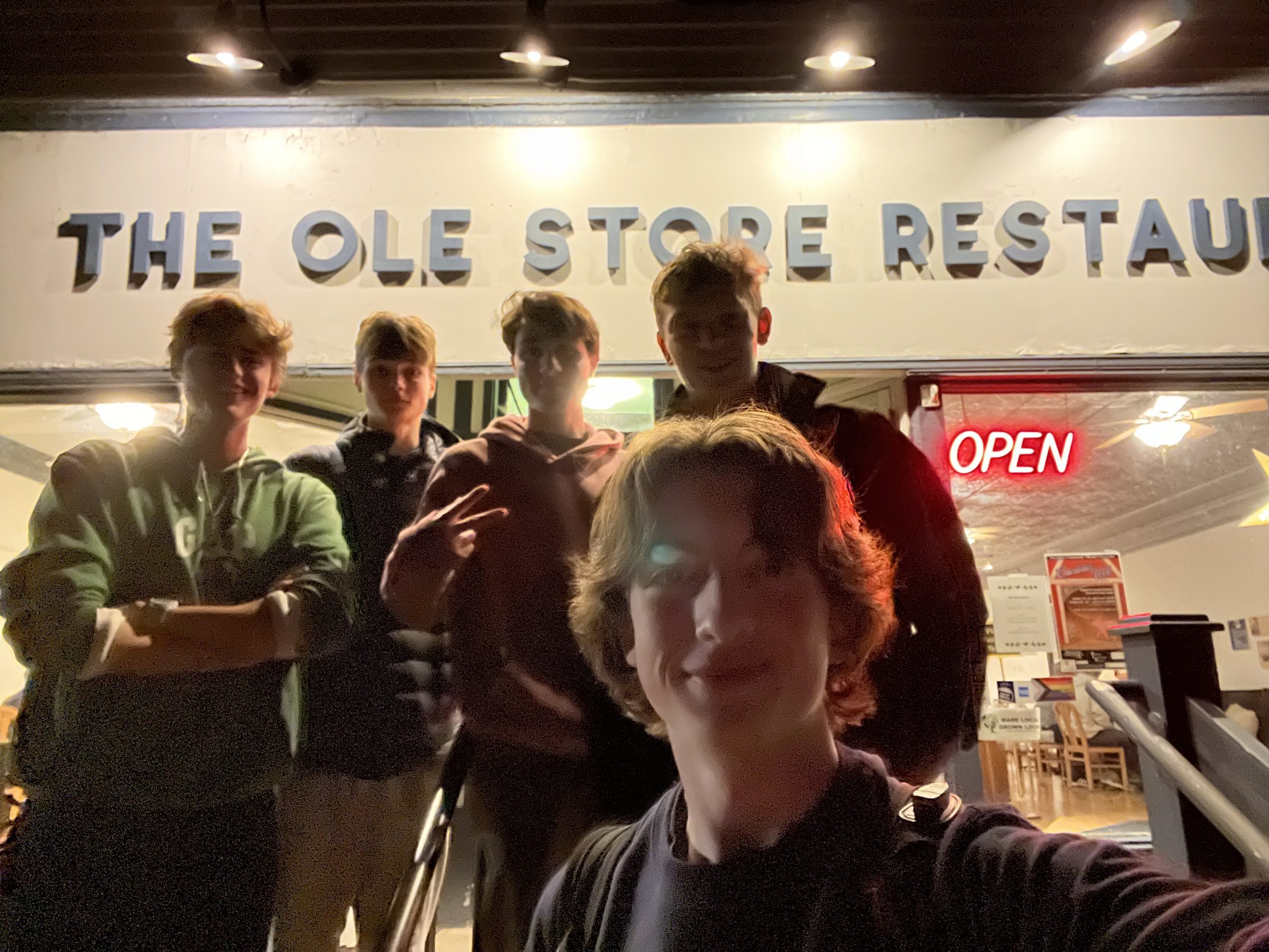People posing in front of restaurant