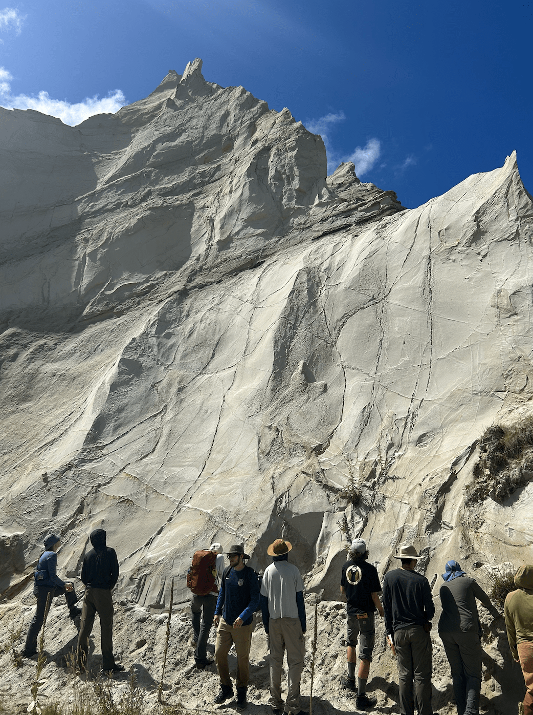 People next to a big white sandstone