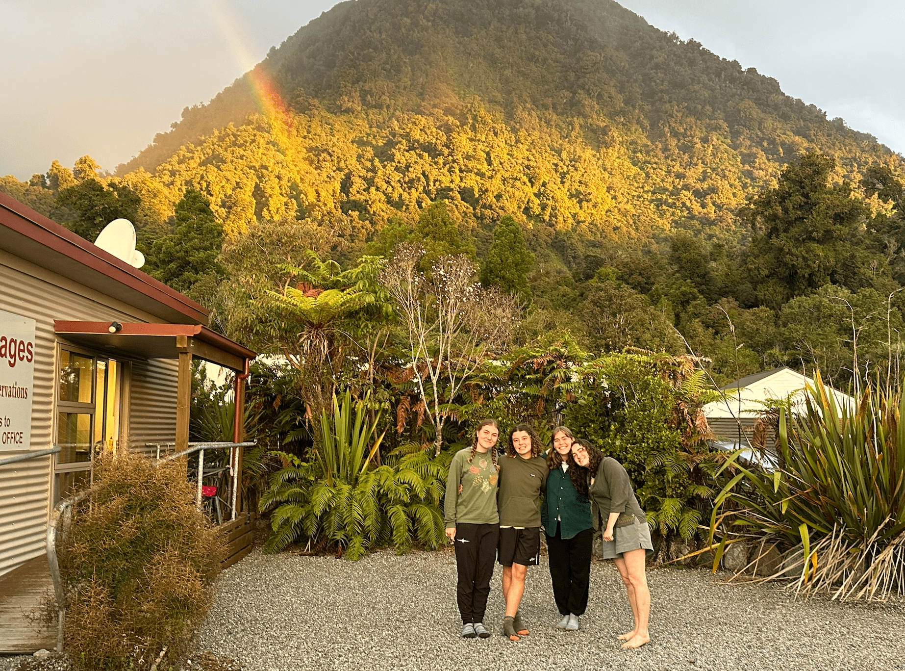 People standing by a rainbow