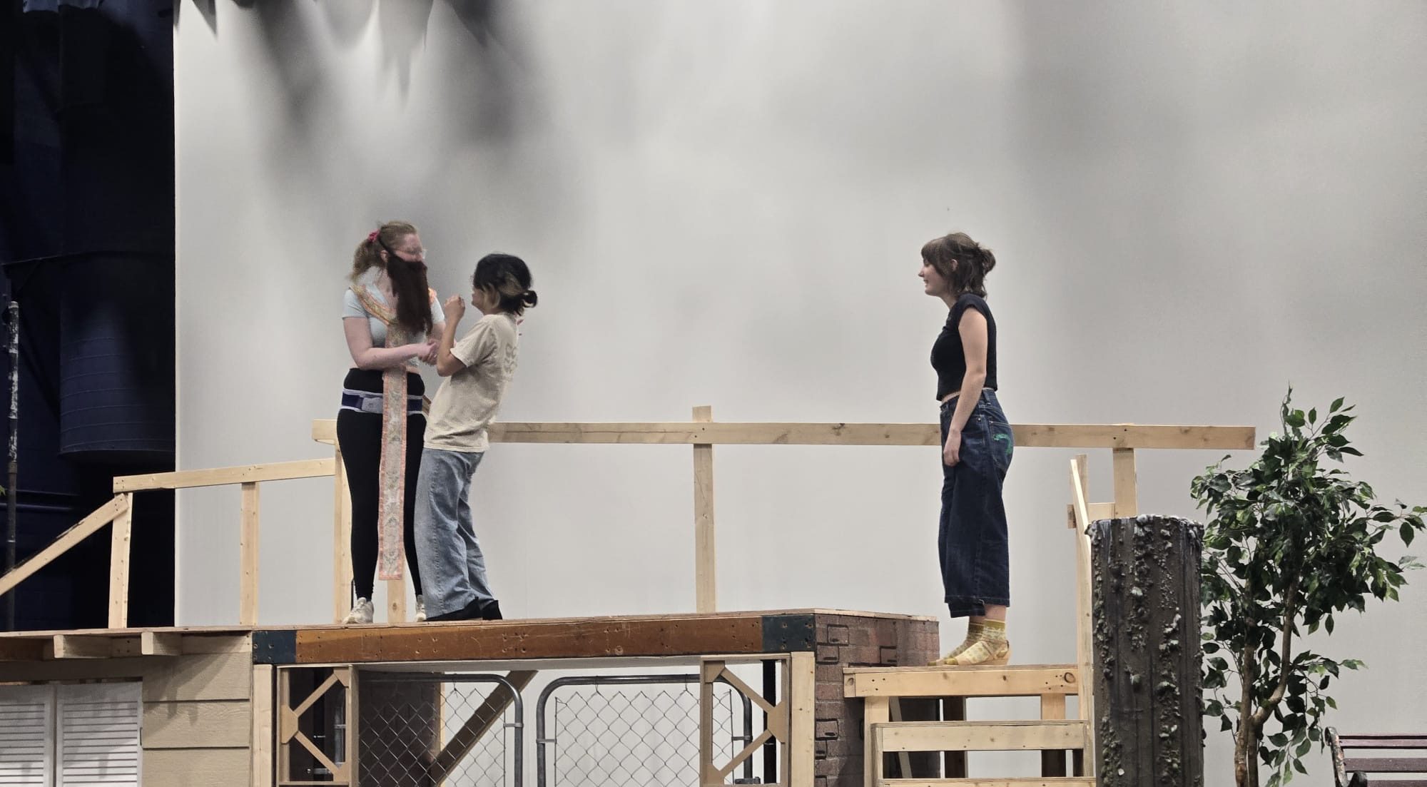 Three students on a stage