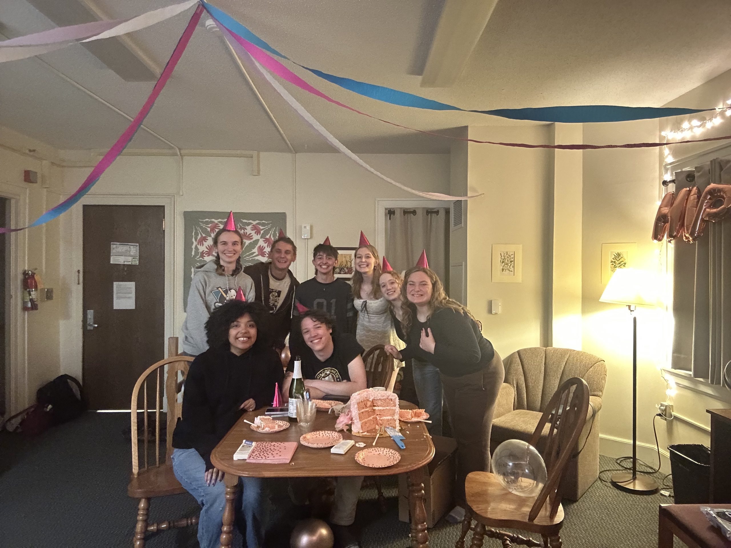 A group of students with party hats on
