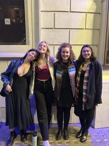 Four girls smiling at the camera in fancy clothes