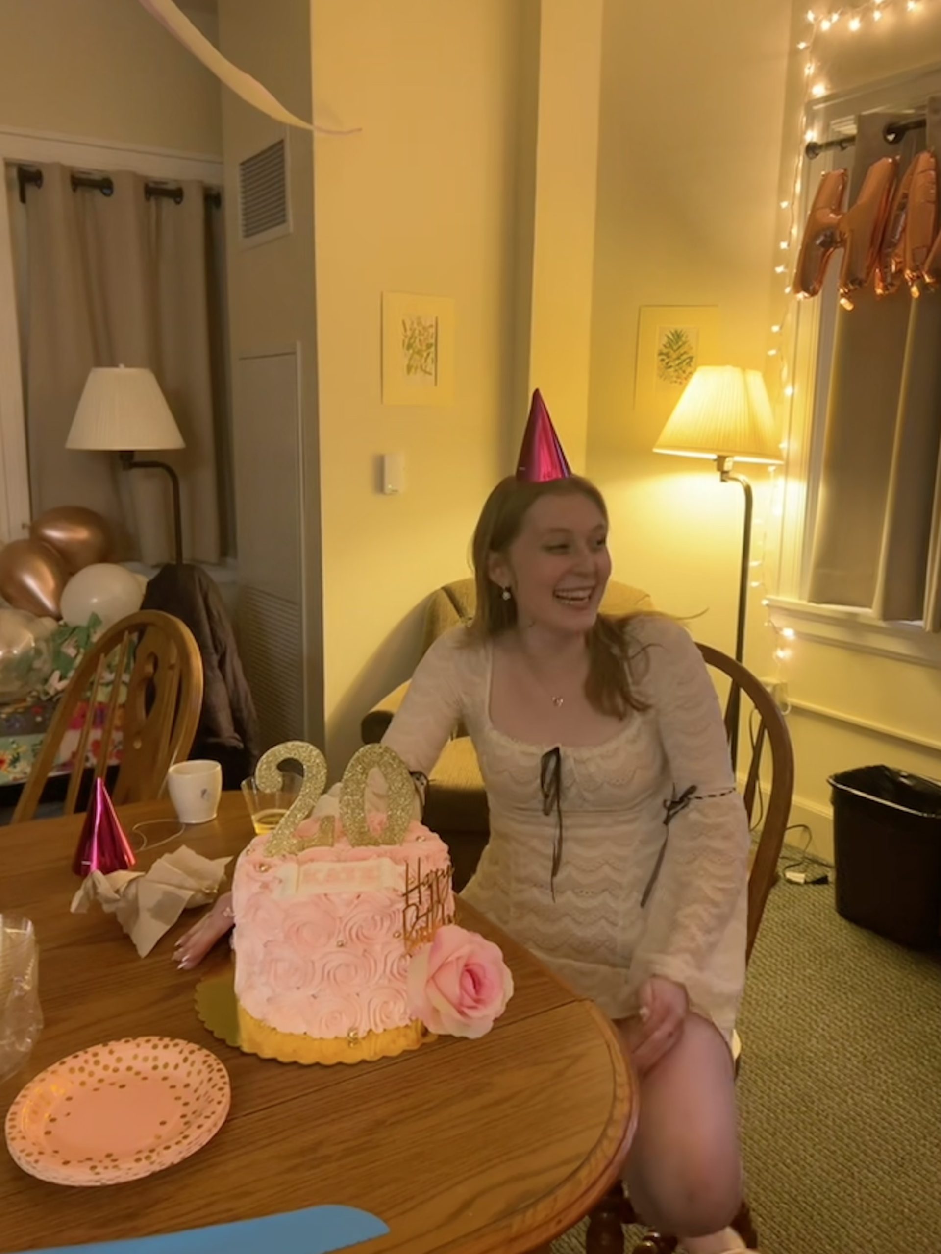 a girl smiling with a cake